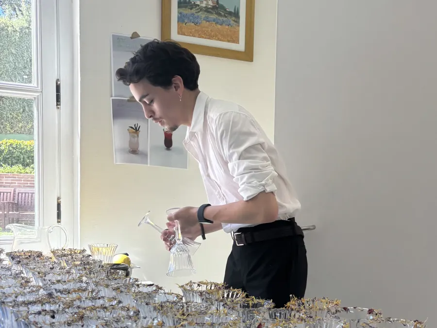 Coctelero preparando copas decoradas para un cóctel de bienvenida